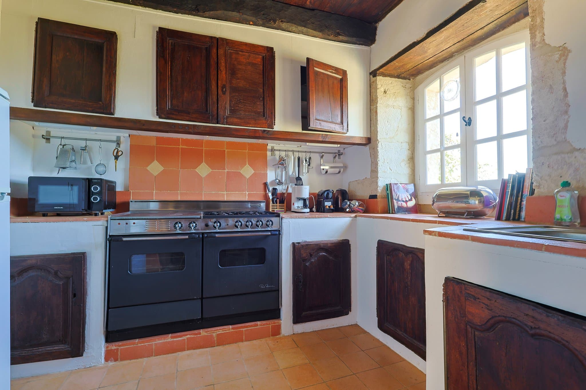 The independent kitchen at The Friends' House, with its antique cabinets and tiled splashback.