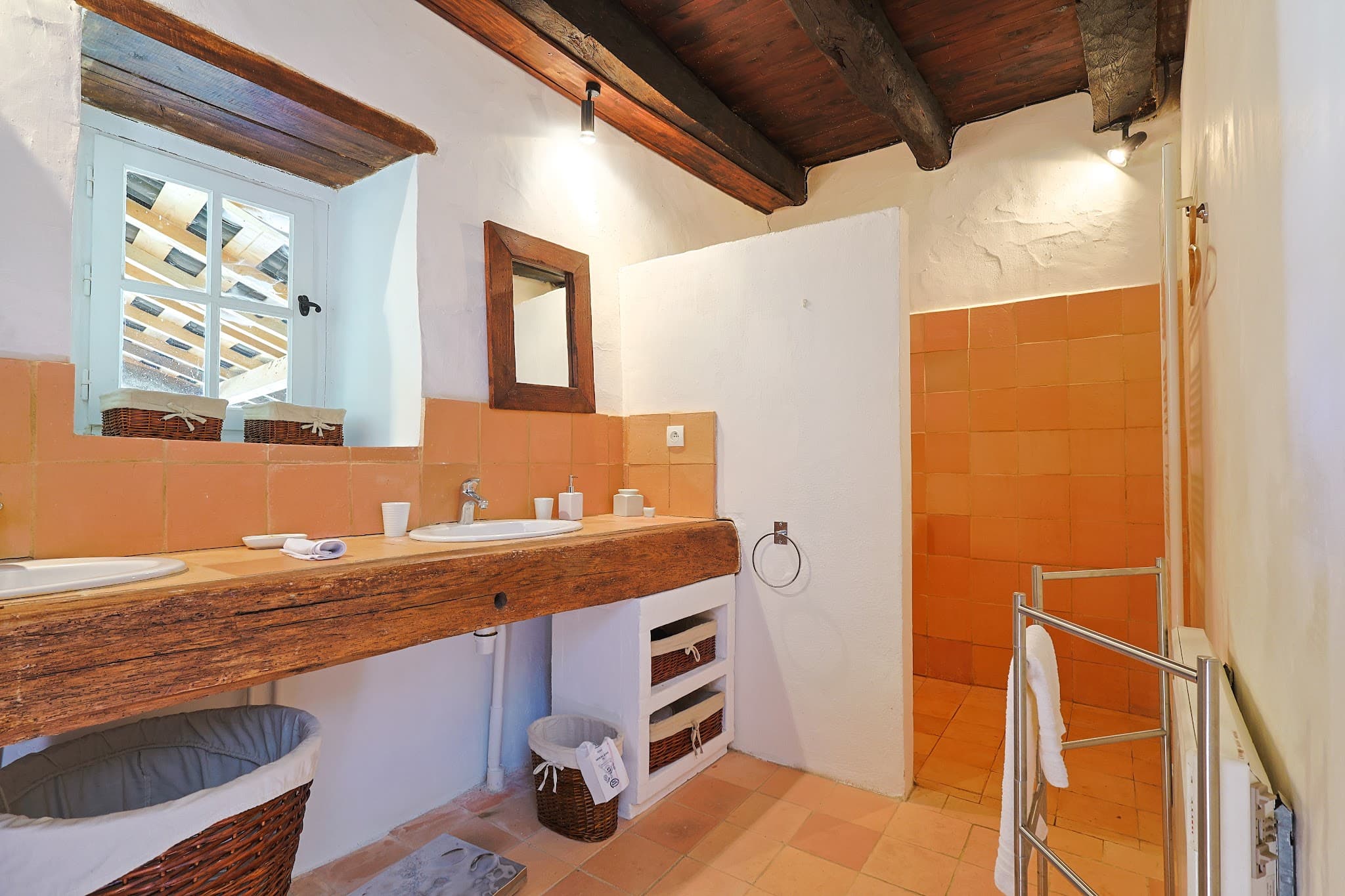 The shower room at The Friends' House, with its wooden vanity and walk-in shower.