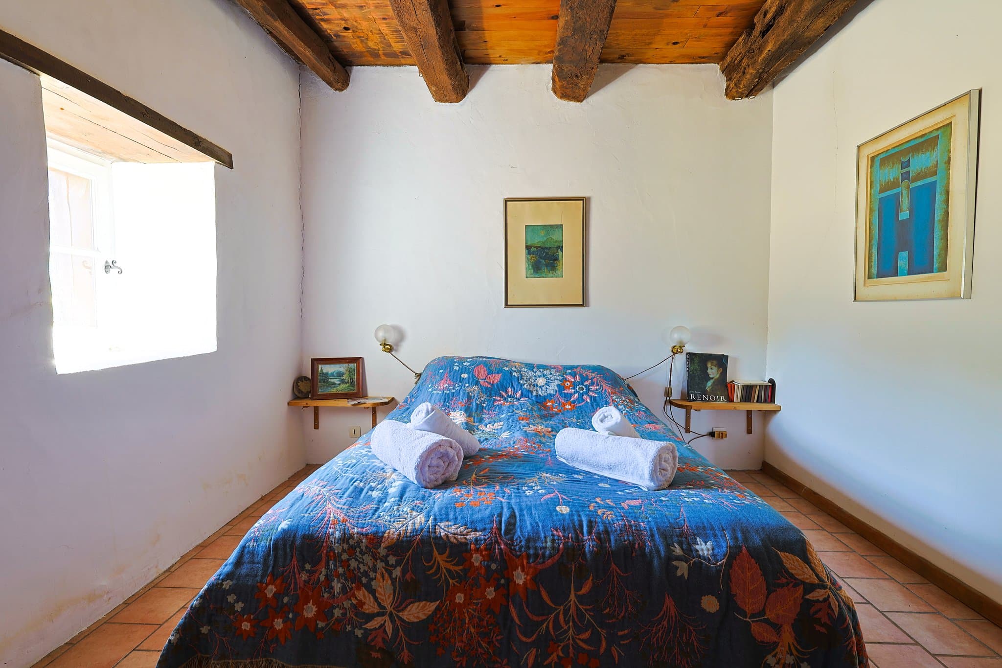 The bedroom at Andrea's House, beneath its exposed beams.
