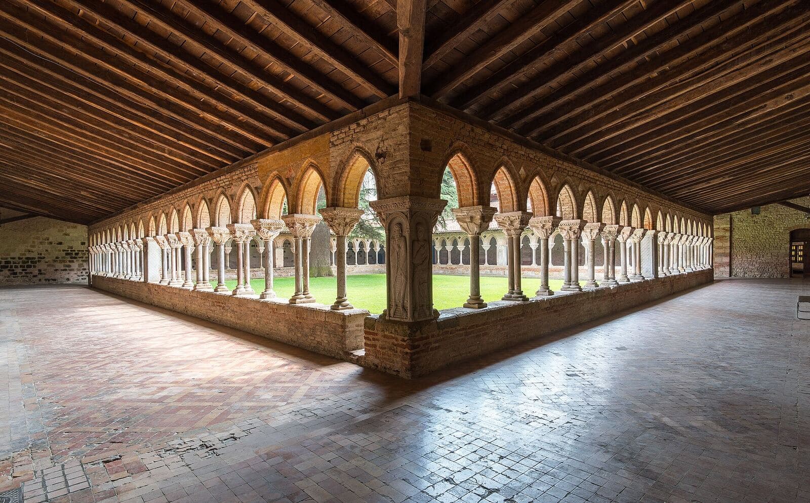 The cloister of Moissac abbey, with its arcades and timber roof.