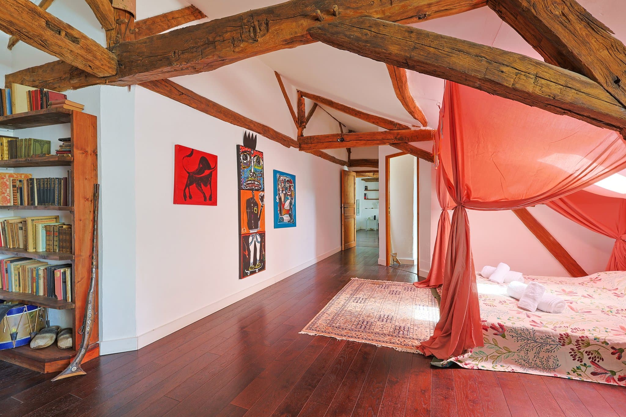 A first-floor living area at Chez Momône, with its bookshelves and contemporary artwork.