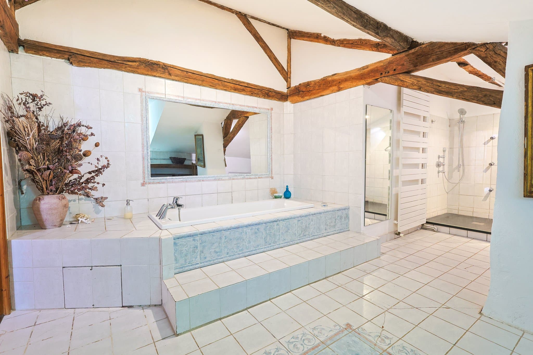 A first-floor bathroom at Chez Momône, with a bathtub and separate shower.